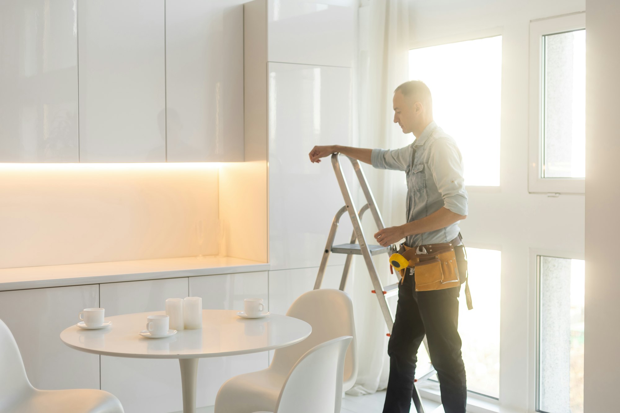 Builder handyman with construction tools. House renovation background.