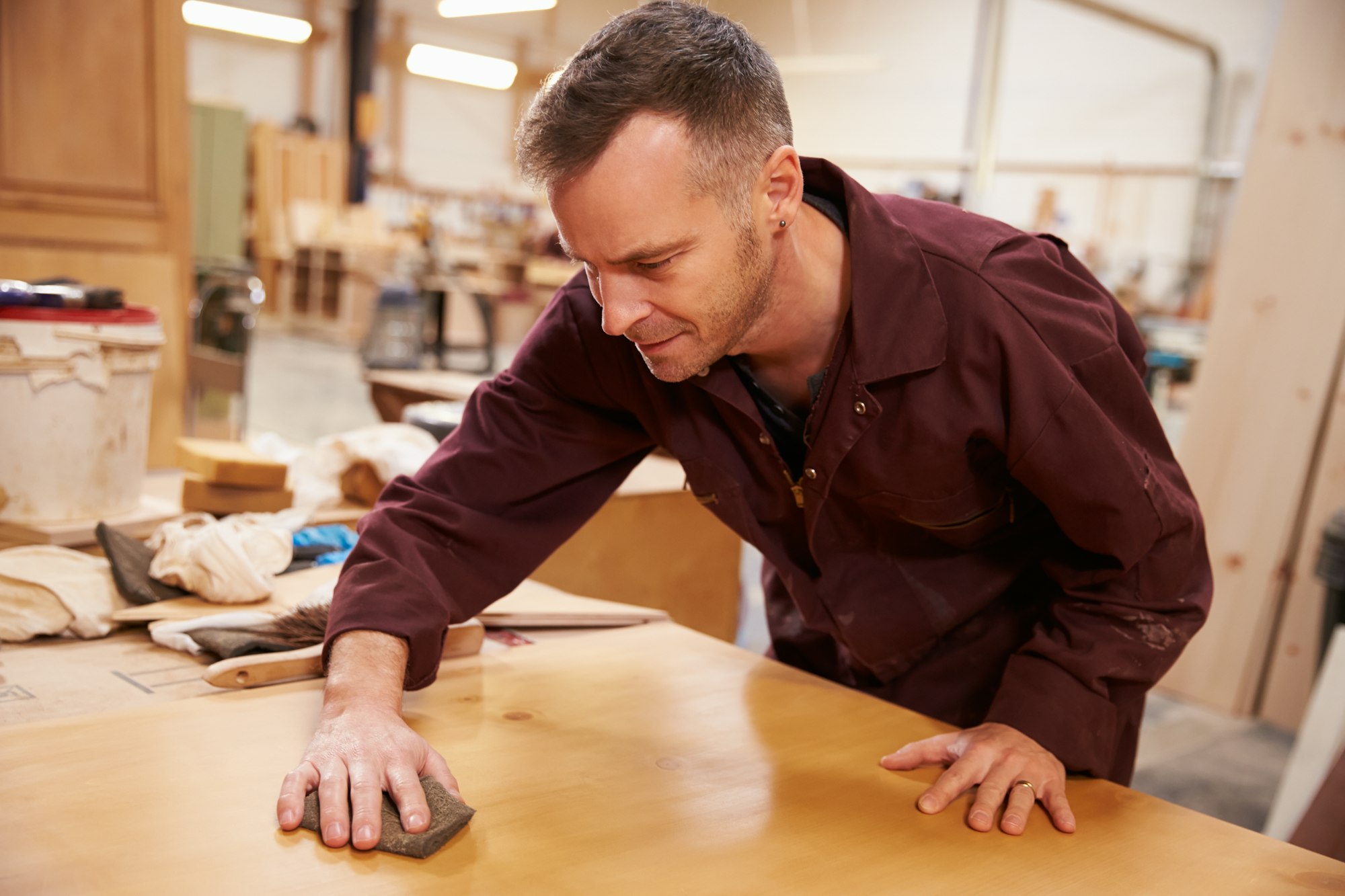 Carpenter Finishing Wood In Carpentry Workshop