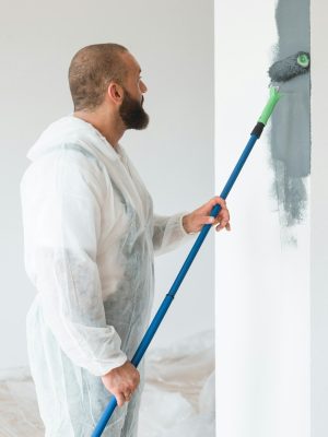 Professional renovation crew painting walls of new build apartment